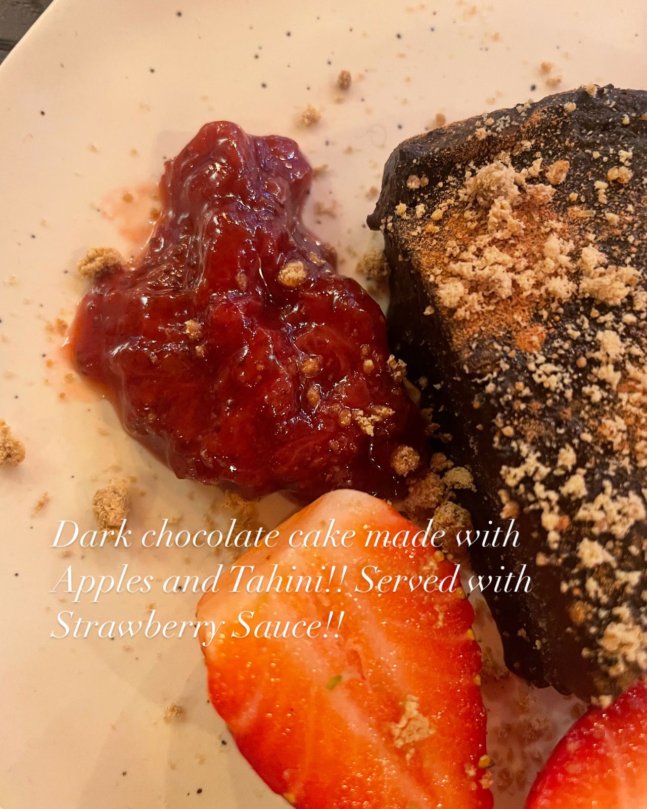 Dark Chocolate Cake made with Apples Tahini served with Strawberry Souce